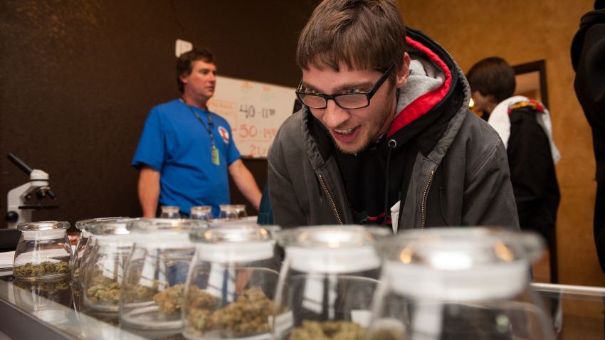 Tyler Williams of Blanchester, Ohio, looks over marijuana strains at the 3-D cannabis dispensary on January 1 in Denver, Colorado.

