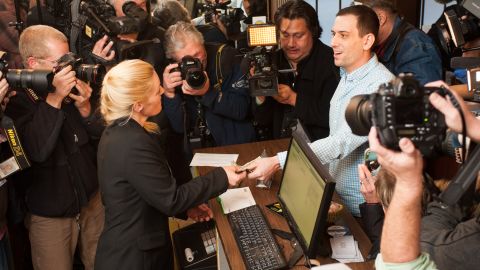 Iraq war veteran Sean Azzariti, right, makes the first legal recreational marijuana purchase in Colorado.