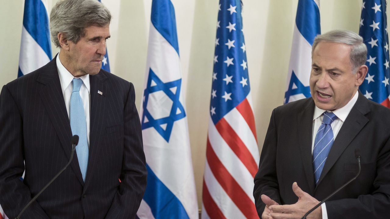 U.S. Secretary of State John Kerry listens on Thursday as Israeli Prime Minister Benjamin Netanyahu makes a statement before a meeting at Netanyahu's office in Jerusalem.