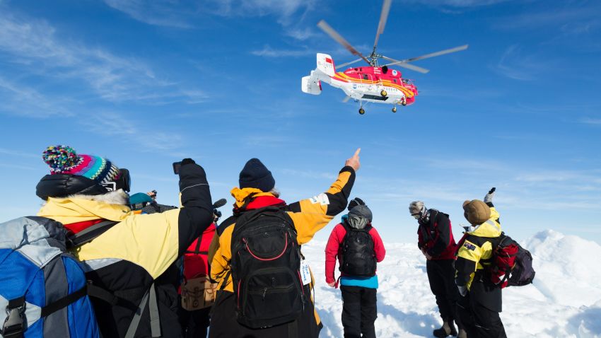 This image taken by expedition doctor Andrew Peacock of www.footloosefotography.com on January 2, 2014 shows a helicopter from the nearby Chinese icebreaker Xue Long above passengers from the stranded Russian ship MV Akademik Shokalskiy as the first helicopter rescue takes place after over a week of being trapped in the ice off Antarctica. The helicopter mission to rescue 52 passengers trapped on the icebound Russian research ship finally got underway in Antarctica on January 2 after a number of false starts and failed icebreaking attempts. It was expected to take at least five hours to ferry all passengers from the icebound vessel to the Xue Long -- 10 nautical miles distant -- by helicopter, with five flights of up to 12 passengers and a return journey taking 45 minutes. The ship is carrying scientists and tourists who are following the Antarctic path of explorer Douglas Mawson a century ago, details of which at www.spiritofmawson.com, and have been carrying out the same scientific experiments his team conducted during the 1911-1914 Australian Antarctic Expedition -- the first large-scale Australian-led scientific expedition to the frozen continent. RESTRICTED TO EDITORIAL USE AFP PHOTO / MANDATORY CREDIT: Andrew Peacock / www.footloosefotography.comAndrew Peacock/AFP/Getty Images