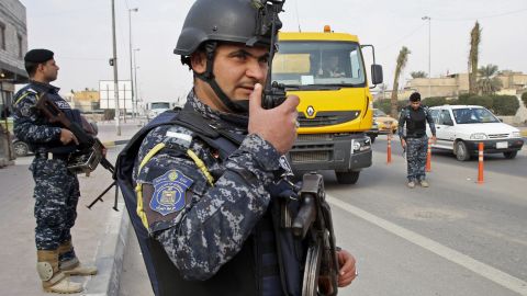 Iraqi federal policemen stand guard at a checkpoint in Iraq on January 2.
