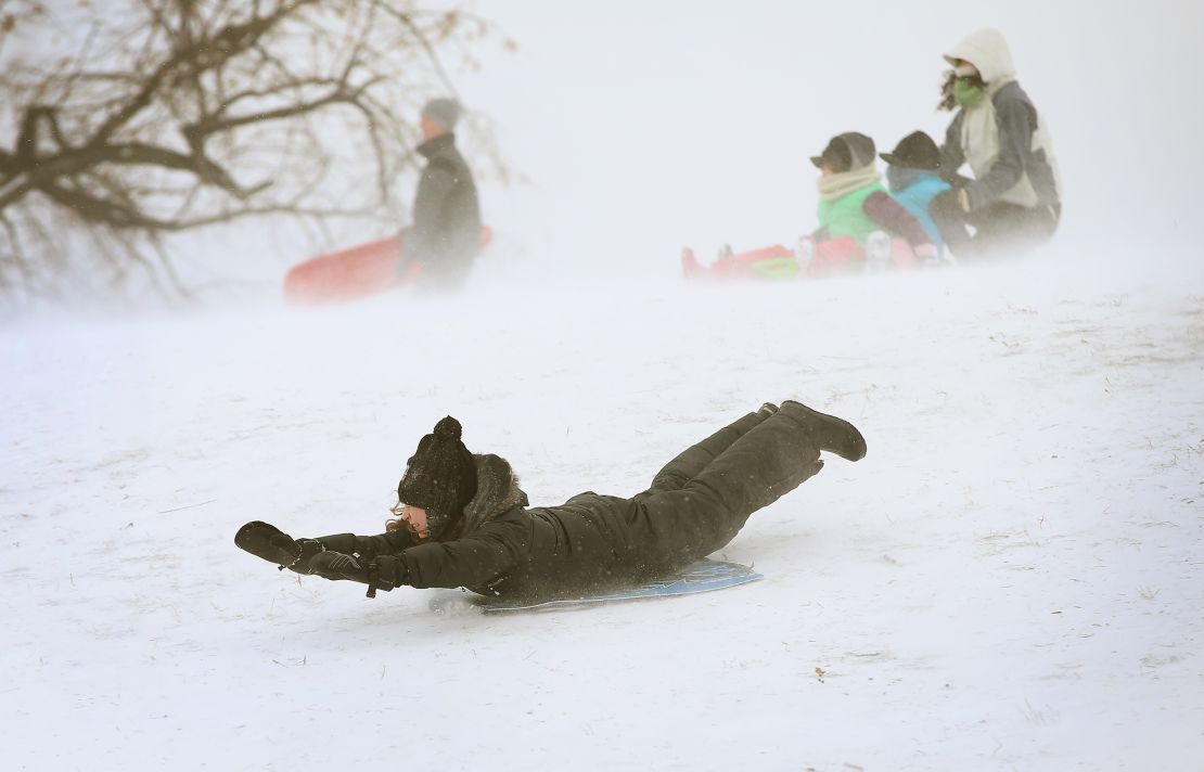 A child slides down a hill on a sled in Chicago's Humboldt Park in January 2014.