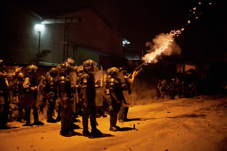 A member of the Cambodian police fires tear gas during a crackdown on striking garment workers on January 2 in Phnom Penh.