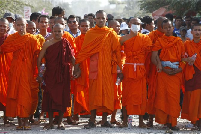 Cambodian Buddhist monks stand together to form a barricade as they participate in a garment workers' strike outside a factory on the outskirts of Phnom Penh on Thursday.