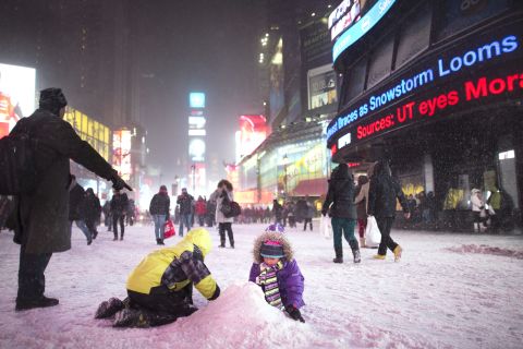 Children make a snow pile in New York's Times Square on January 2.