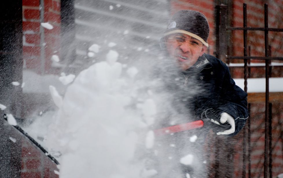 A man shovels snow during the tail end of a snowstorm in Brooklyn on January 3.