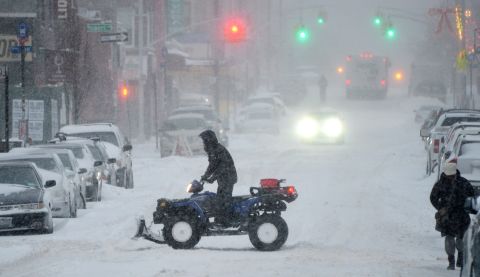 A man rides an all-terrain vehicle through a Brooklyn street on January 3.