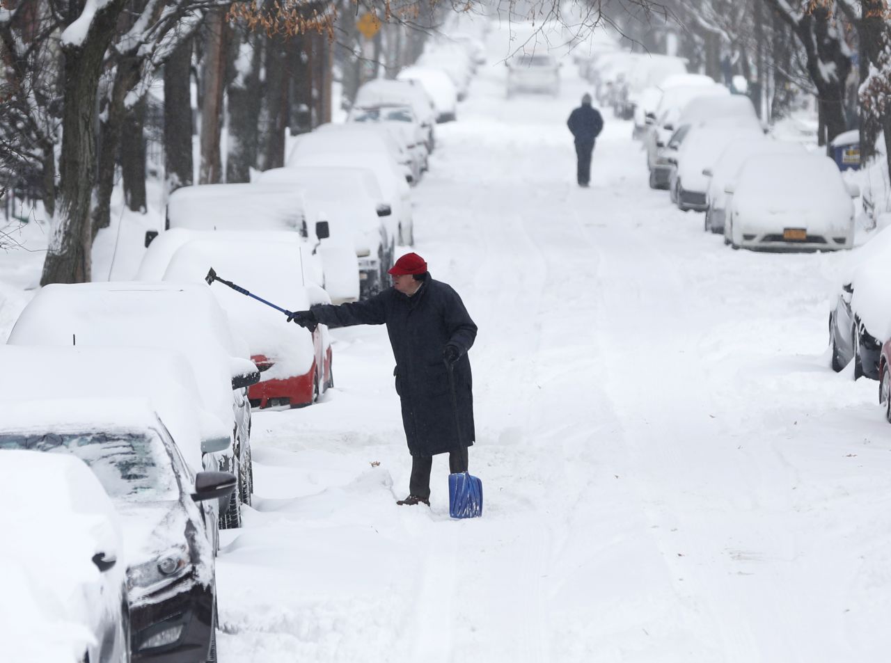 A man clears snow from a vehicle January 3 in Albany, New York.