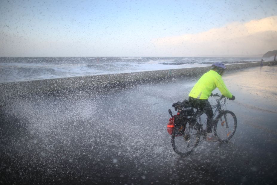 A cyclist gets a soaking on the West Bay seafront in Dorset, England, on January 3. 