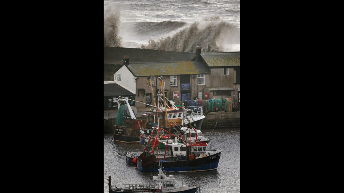 Waves break over the Cobb sea wall on January 3 in Dorset.