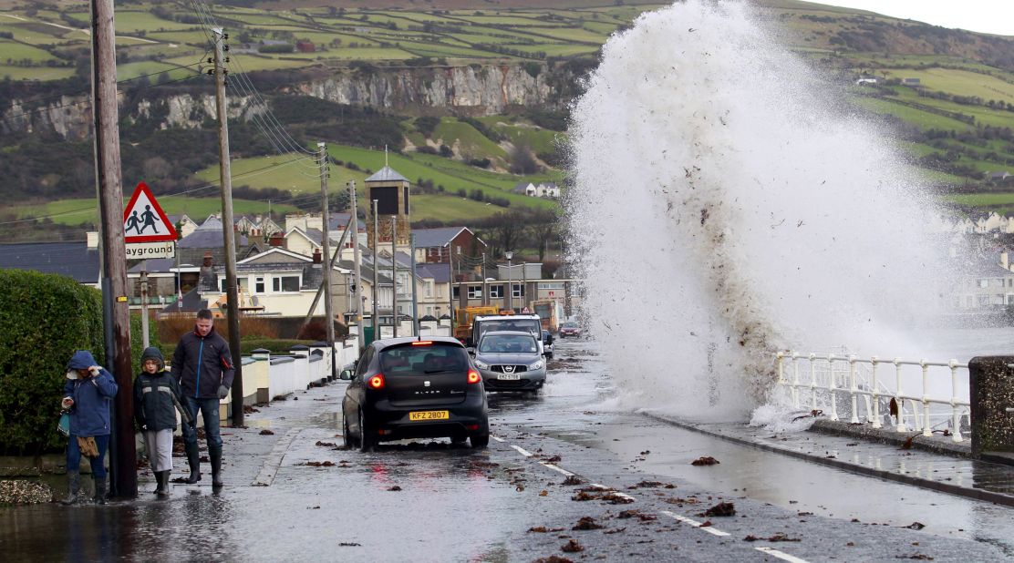 Large waves crash onto a road in the coastal village of Carnlough, Northern Ireland, on January 3. 