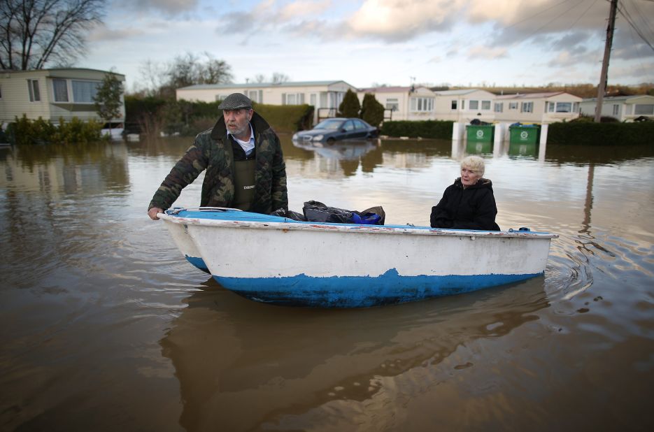 Ian Peacock and Caroline Hine rescue possessions from flooded trailers at the Little Venice Country Park in Yalding, England, on January 2.