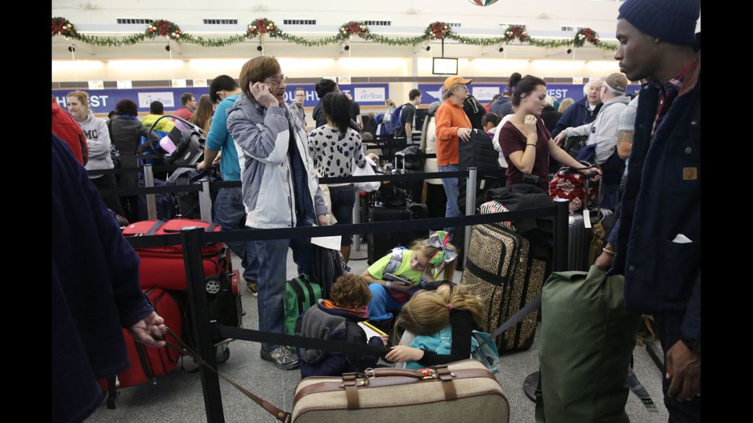 Travelers wait in line January 3 at Chicago Midway International Airport.