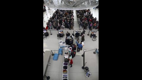 Passengers wait in line at a security checkpoint at JFK Airport on January 3.