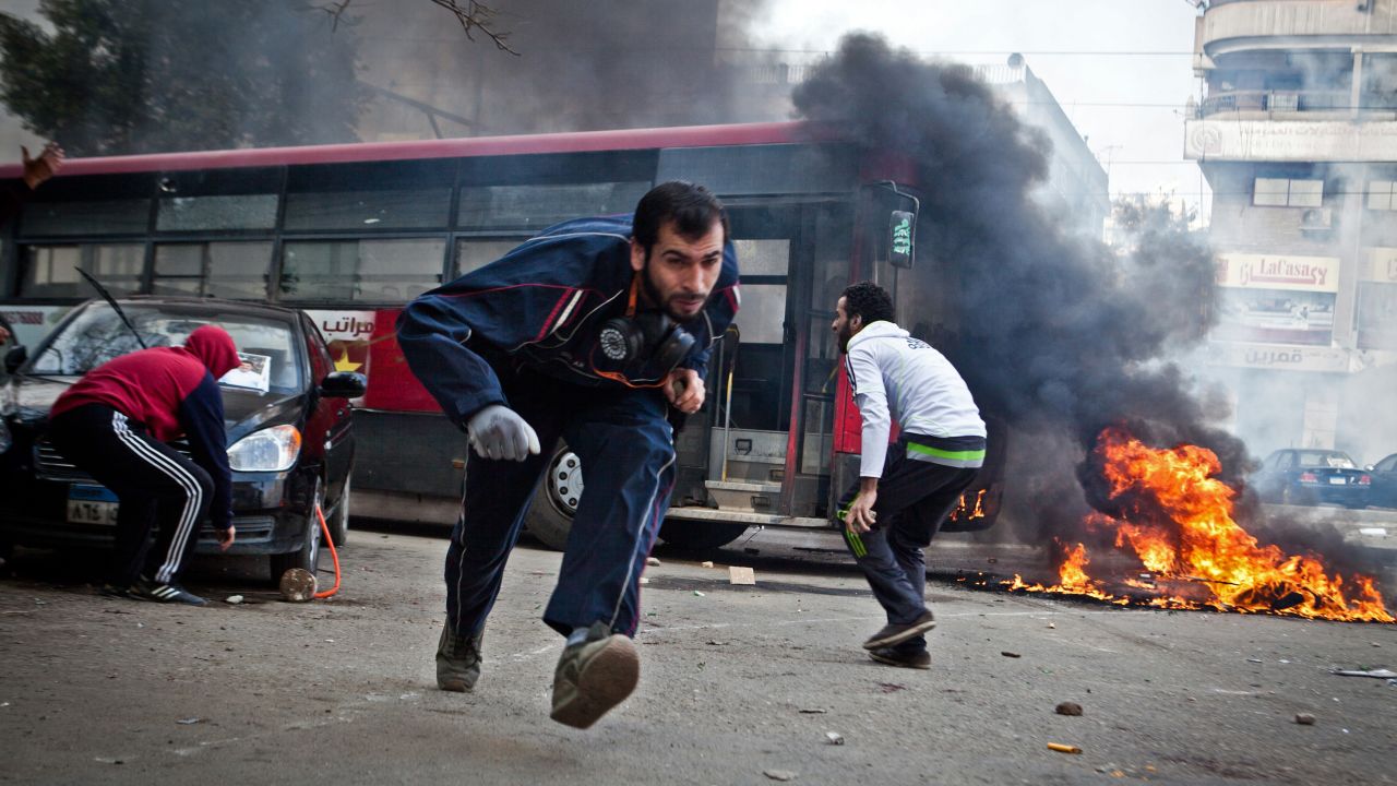 Supporters of Egypt's deposed president Mohamed Morsi run for cover during clashes in Cairo's Nasr City on January 3.