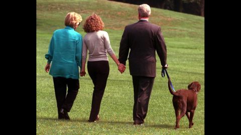 President Clinton, his daughter Chelsea, center, and wife Hillary walk with Buddy Tuesday, Aug. 18, 1998, from the White House toward a helicopter as they depart for vacation enroute to Martha's Vineyard, Mass. (AP Photo/Roberto Borea)
