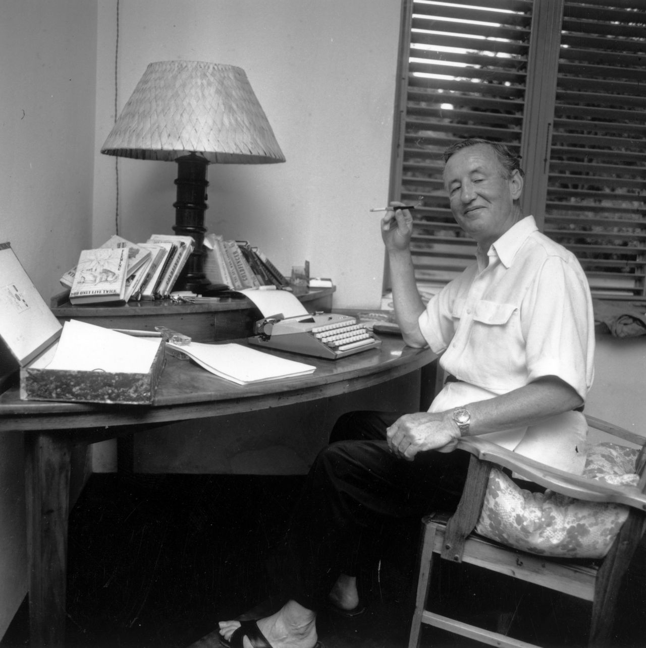 Ian Fleming, author of the James Bond series of spy novels, works at his Jamaica home, nicknamed "Goldeneye," in this undated photo.