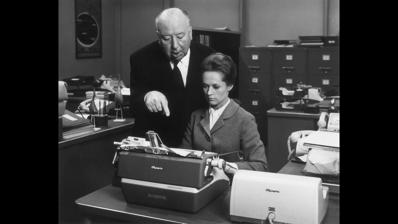 Alfred Hitchcock, who directed more than 50 films including "Psycho" and "The Birds," works with actress Tippi Hedren on the set of his 1964 film "Marnie." 