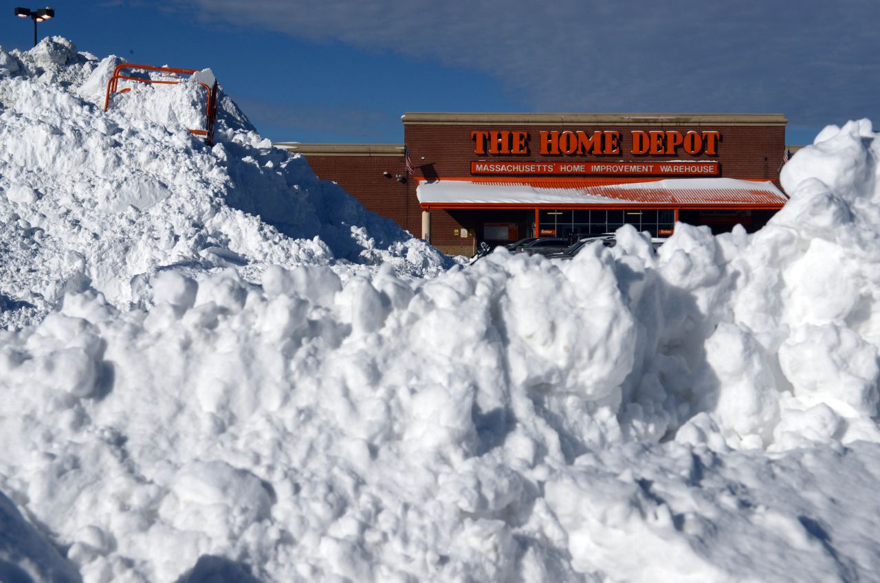 Snow is piled high in front of a Home Depot in Boston on January 4.