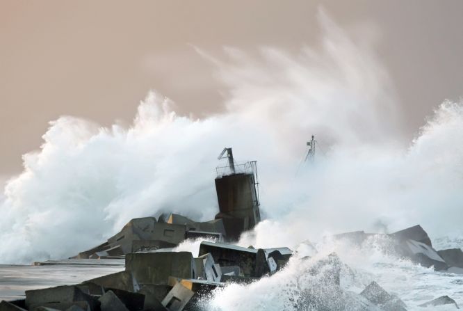 Waves crash against a breakwater along the San Juan de Nieva coast near Aviles in northern Spain on January 4. 