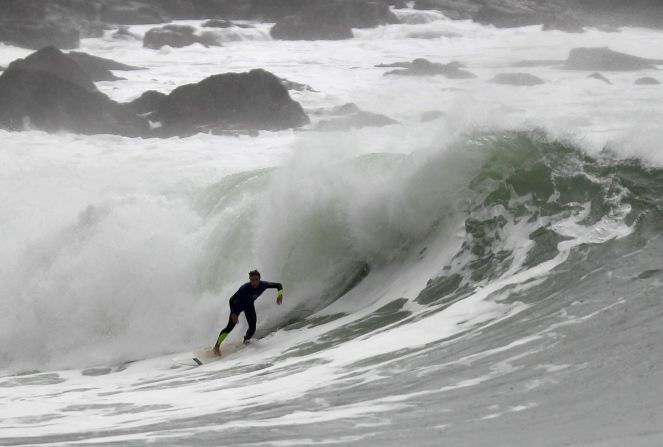 A surfer takes advantage of waves generated by strong winds in Zumaia in northern Spain on January 4. 
