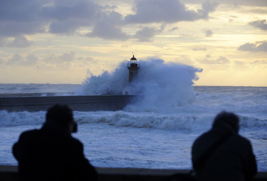 Heavy seas cause waves to crash over a lighthouse at the mouth of the Douro River in Porto, Portugal, on January, 4. 