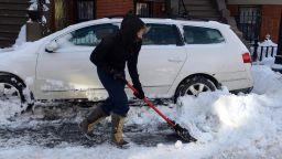 A woman shovels her car out from snow on East Concord Street in the South End after a two day winter storm January 4, 2014 in Boston, Massachusetts.