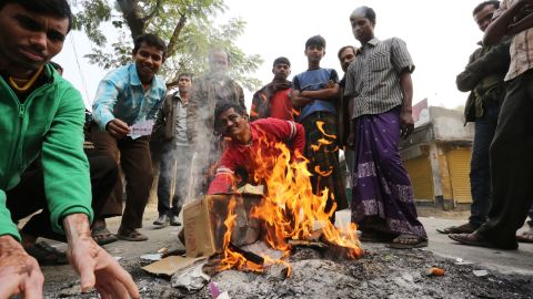 Bangladeshi protestors burn election material at a polling station in the northern town of Bogra on Sunday.