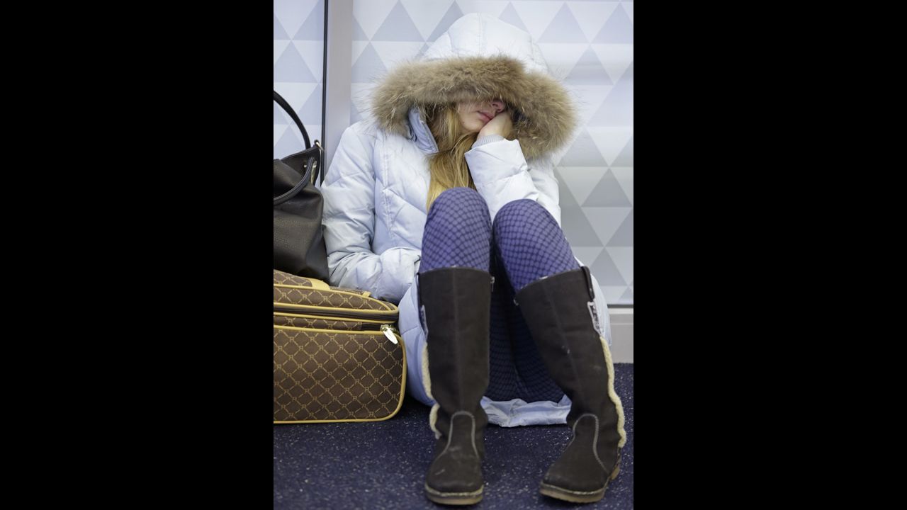 Anna Maksimkina of Yekaterinburg, Russia, sleeps on the floor at John F. Kennedy International Airport in New York after a Delta flight from Toronto to New York skidded off the runway into a snow bank, temporarily halting all flights January 5.