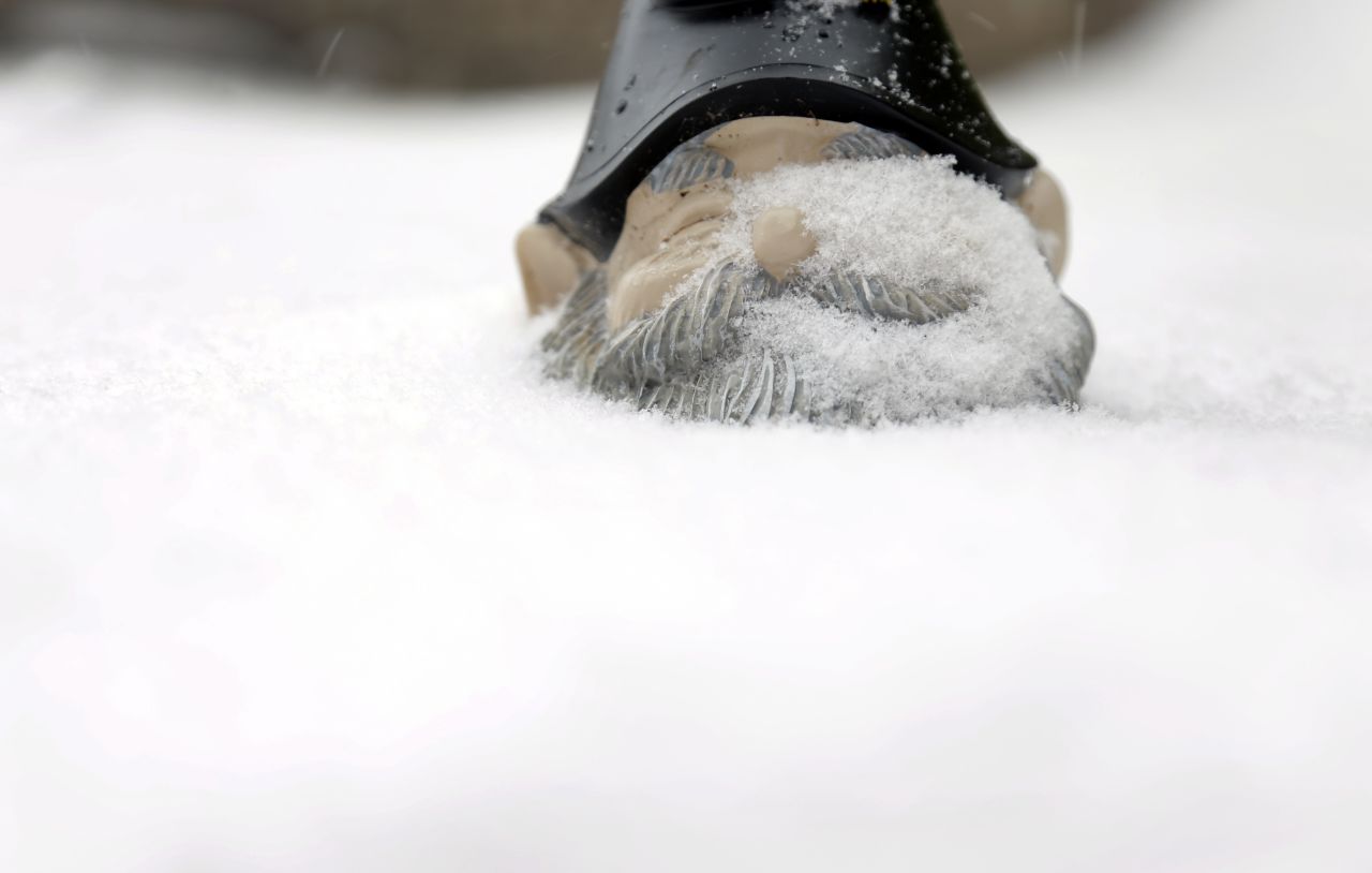 Snow covers a garden gnome in St. Louis on January 5.