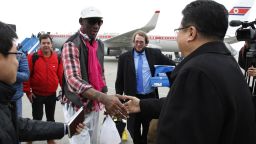 Former NBA star Dennis Rodman shakes hands with North Korea's Sports Ministry Vice Minister Son Kwang Ho upon his arrival at the international airport in Pyongyang on Monday, January 6.