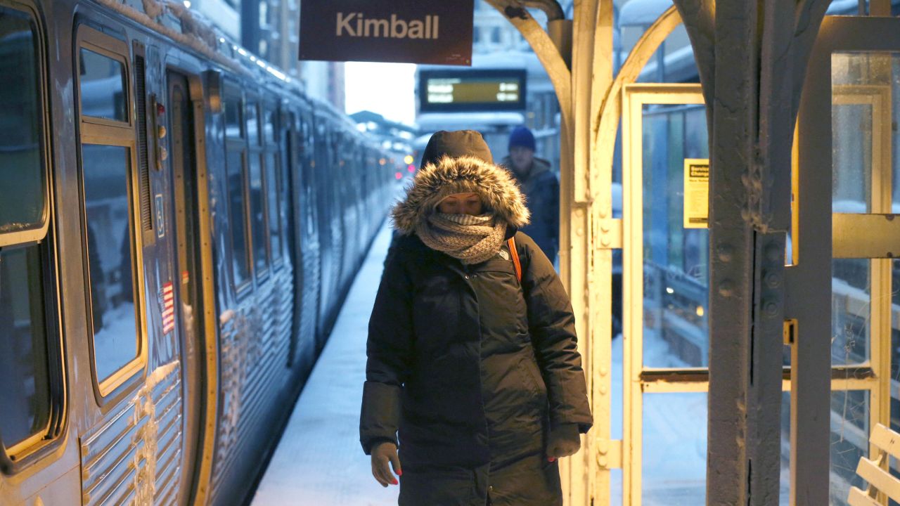 A commuter walks past warming lamps at a Chicago train station on January 6.