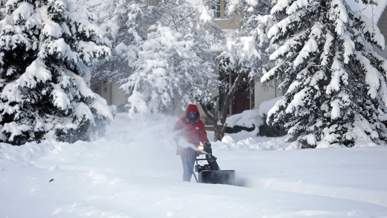 A man clears the sidewalk in front of his home in Carmel, Indiana, on January 6.