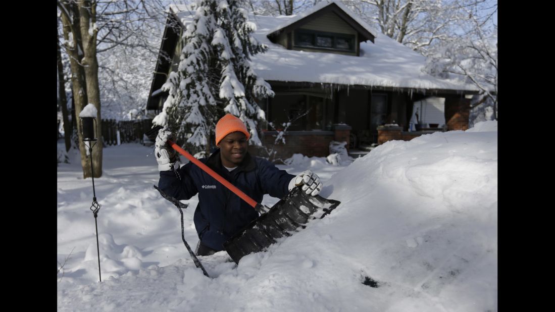 A man shovels the snow off his car in Indianapolis on January 6.