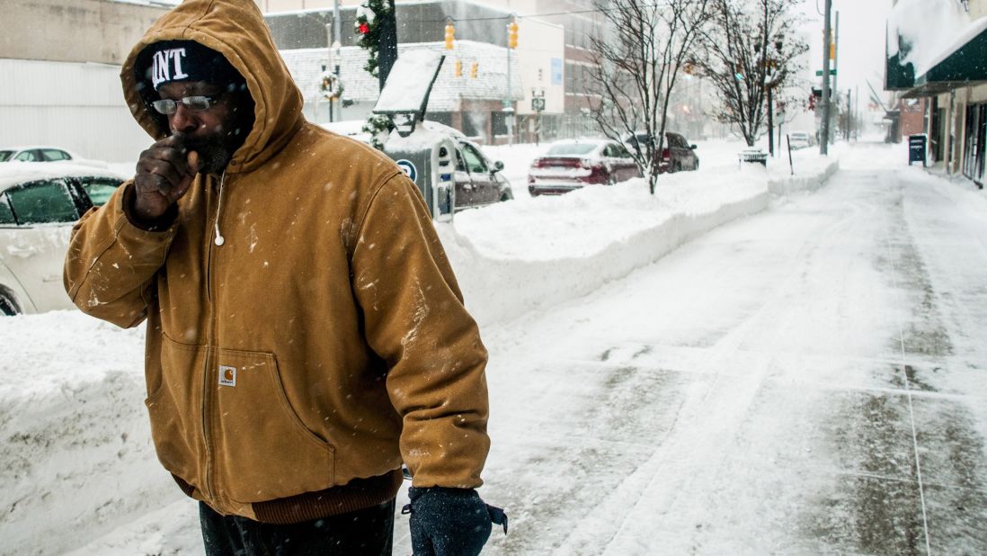 A man warms his hand while running errands in Flint, Michigan, on January 6. 