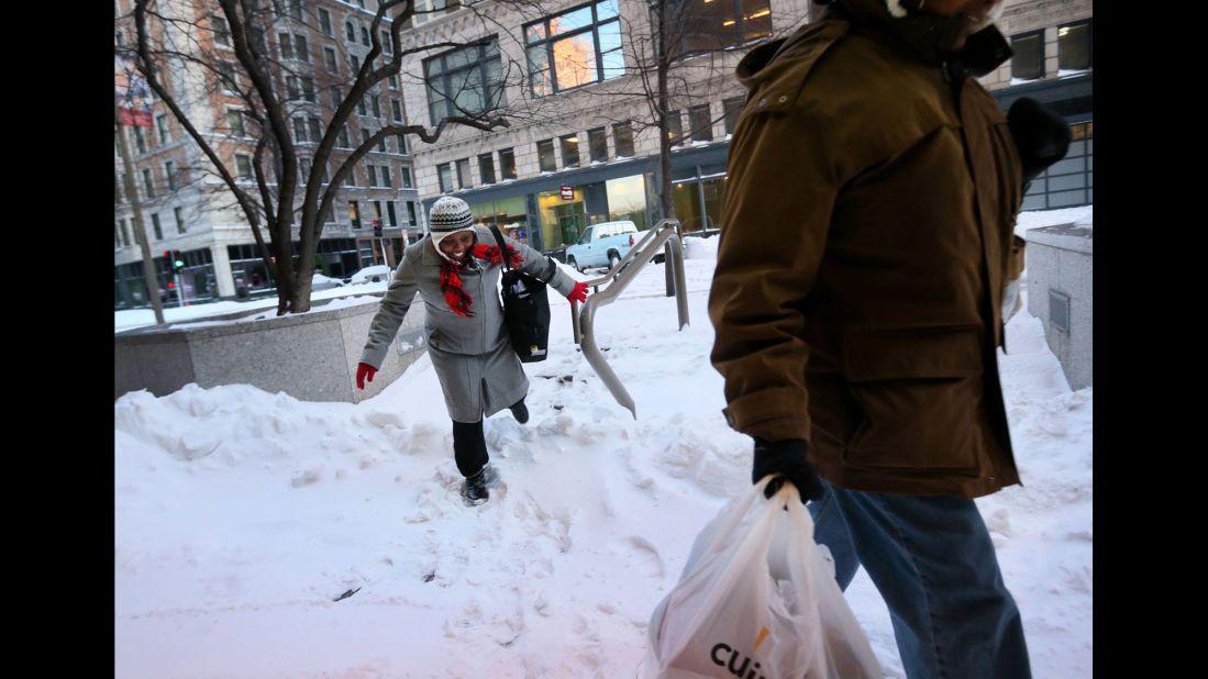 A woman makes her way through a snow drift in downtown St. Louis on January 6.