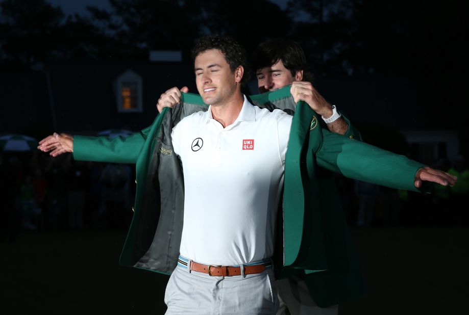 Bubba Watson helps Scott don the green jacket at the 2013 Masters after the Australian won his first major after a playoff with Angel Cabrera. 