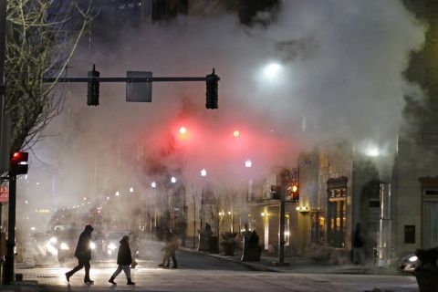 With temperatures nearing 0 degrees, a cloud of steam from a manhole blows across an intersection in downtown Pittsburgh on January 6.