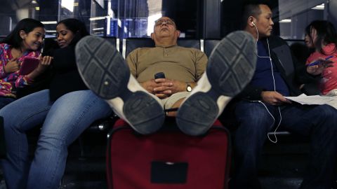 A man takes a nap at Logan International Airport after his flight was canceled Monday, January 6.
