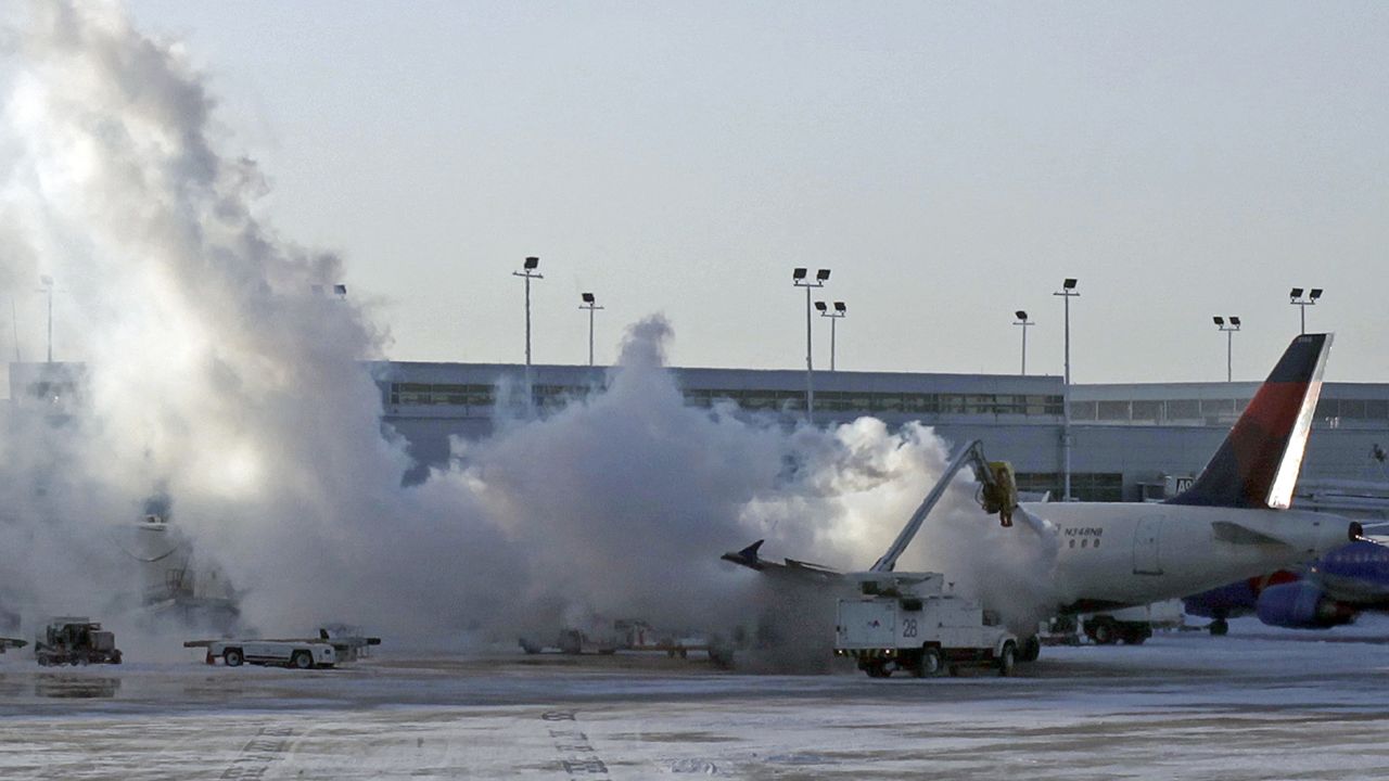 A Delta Air Lines plane is de-iced at Chicago Midway International Airport on January 6.