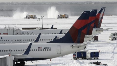 Snowplows clear snow from one of the runways January 3 at John F. Kennedy International Airport in New York City.