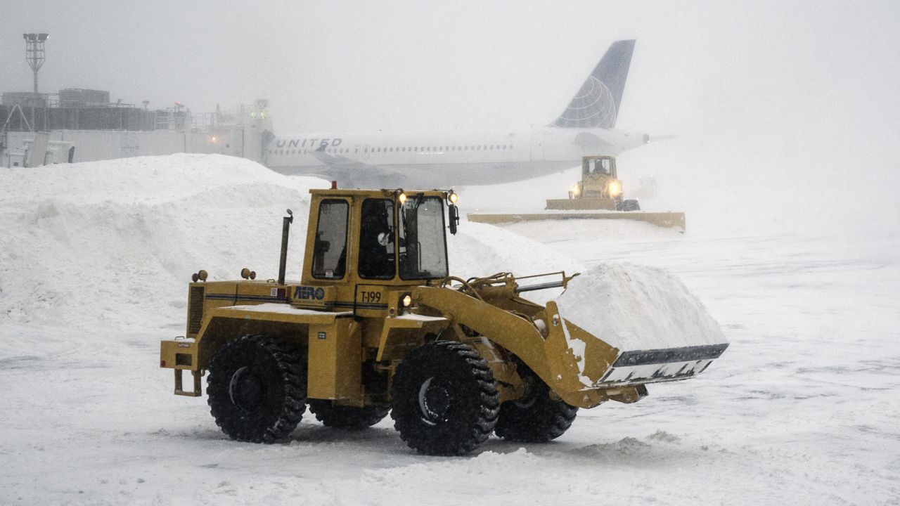 An airport employee clears snow at New York's LaGuardia Airport on January 3.