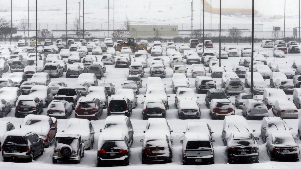 Cars sit covered in snow at Chicago O'Hare International Airport on Thursday, January 2.