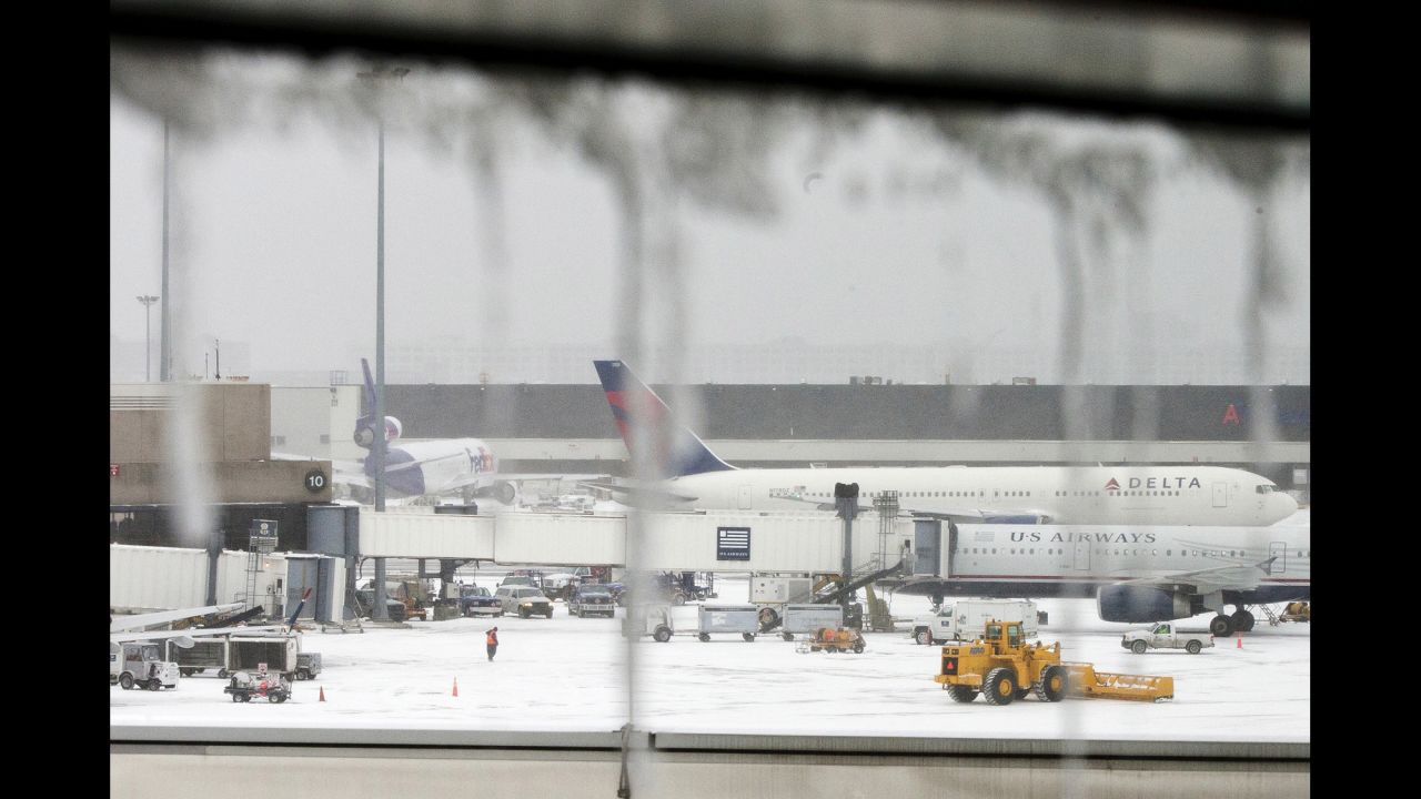 Icicles hang from a window looking onto airplanes at Logan International Airport in Boston on January 2.