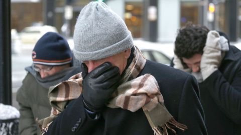 Men battle the bitter wind as they walk in Chicago on January 6.