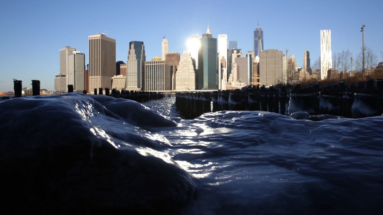Ice forms around rocks on the Brooklyn waterfront, across from Lower Manhattan, on January 7, in New York City.