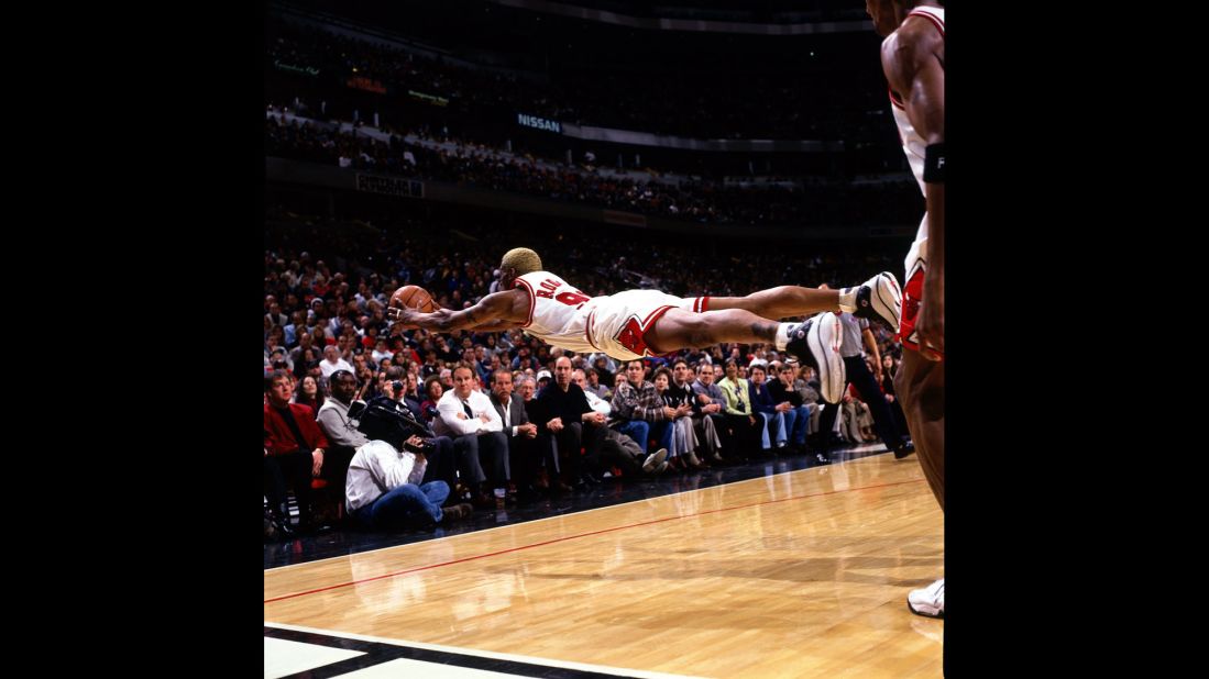 Rodman dives for a loose ball during a game in 1997. Rodman is one of the NBA's all-time greatest rebounders, leading the league in that category from 1992 to 1998.