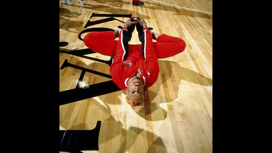 Rodman stretches before a game in Seattle in 1996.