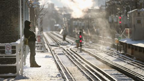 A passenger waits for a train to arrive in Chicago on January 7, when temperatures were below zero.
