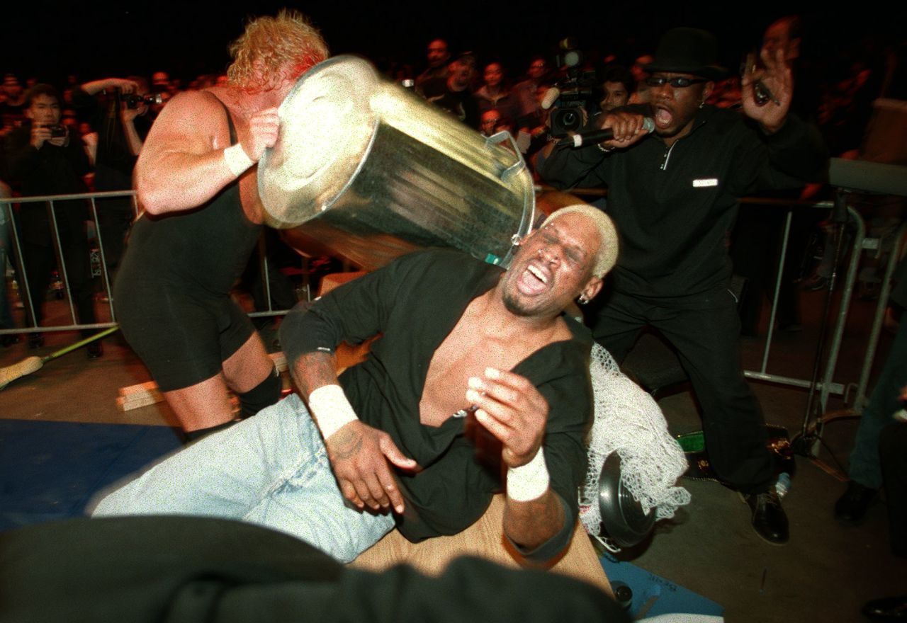 Rodman is hit with a trash can by Curt Hennig during a pro wrestling match in Sydney in 2000.